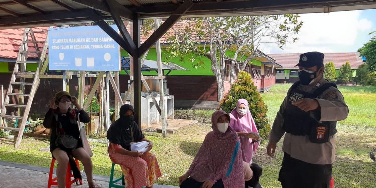 Personil Polsek Seruyan Hilir Amankan Penyaluran BST dan Awasi Prokes