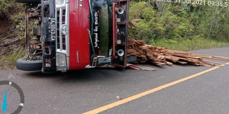 Truk Bermuatan Kayu Olahan Terguling di Jalan Raya